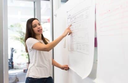 woman giving presentation at whiteboard